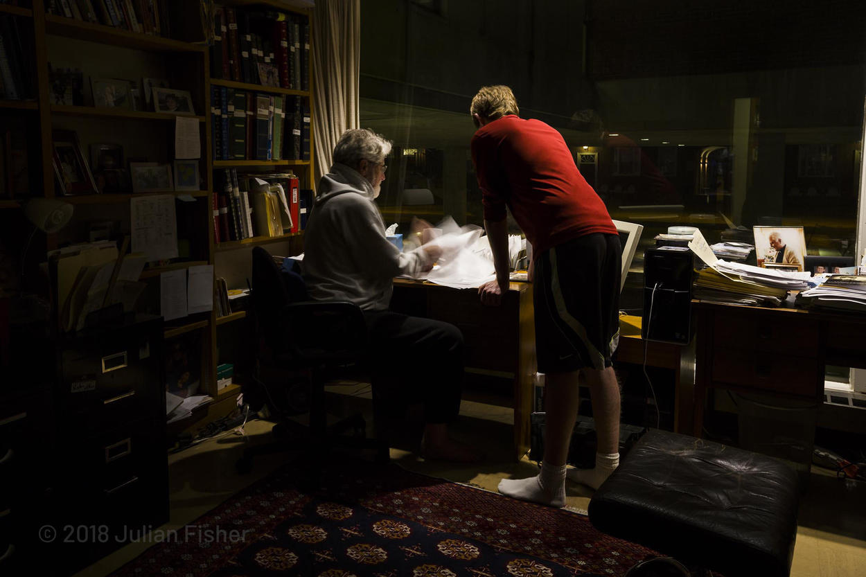 man and son filling out forms at night