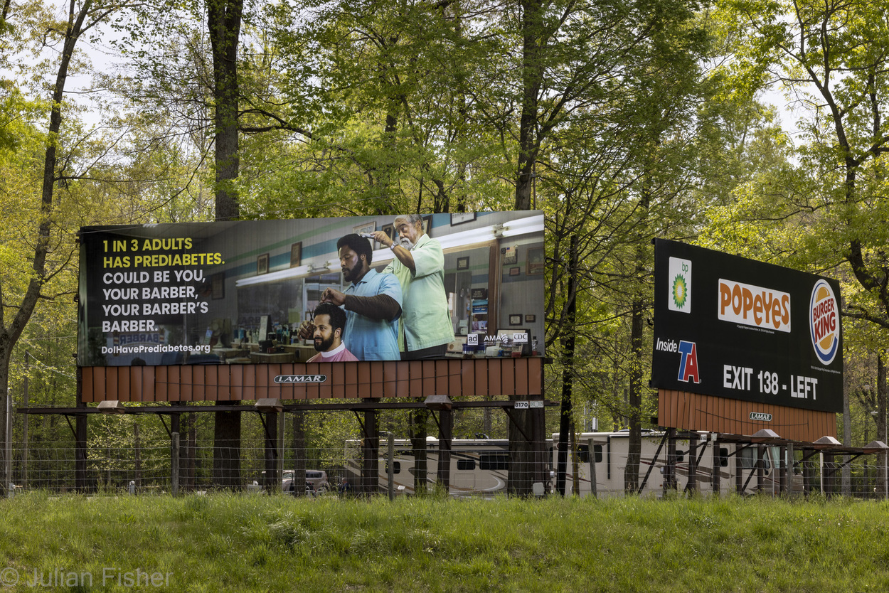 billboard showing barber cutting hair