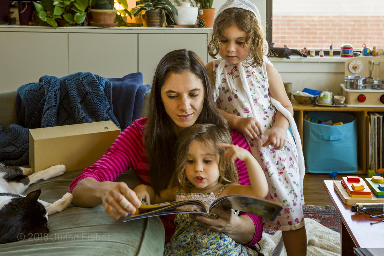 mother reading to daughters
