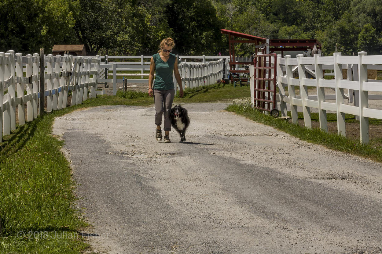 woman and dog on dirt road