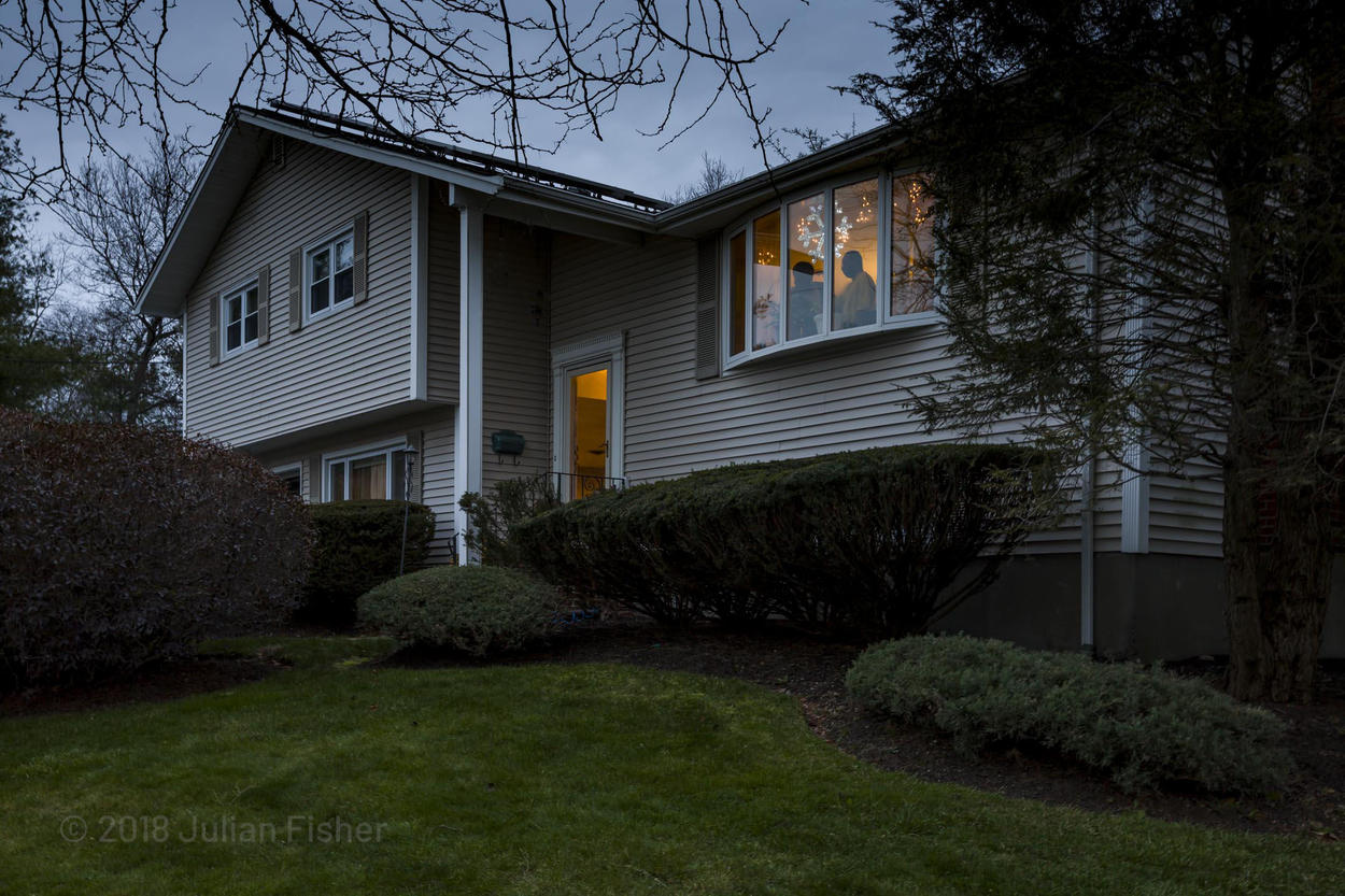 view of exterior of house in new england at dusk