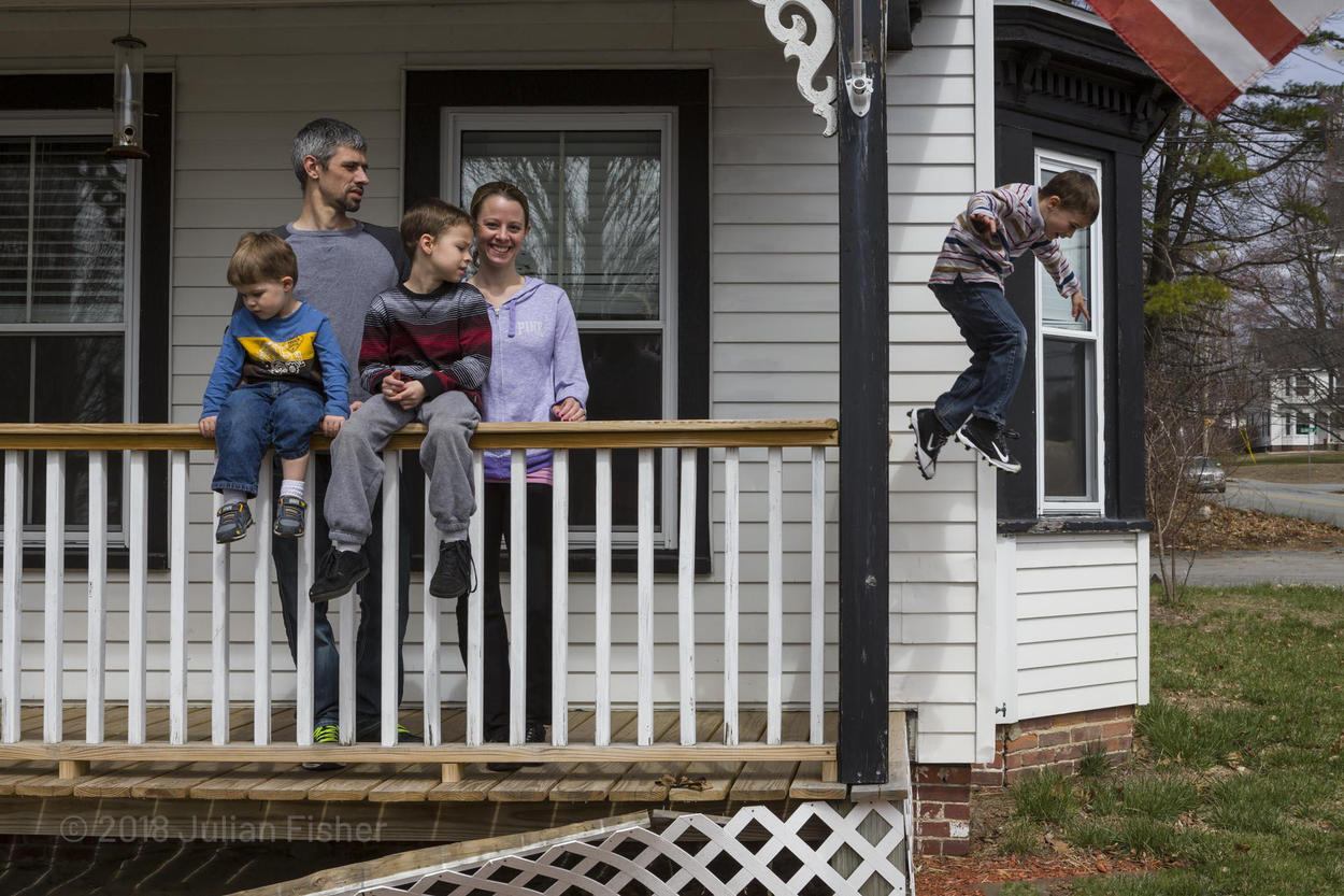 family on their porch  son jumping